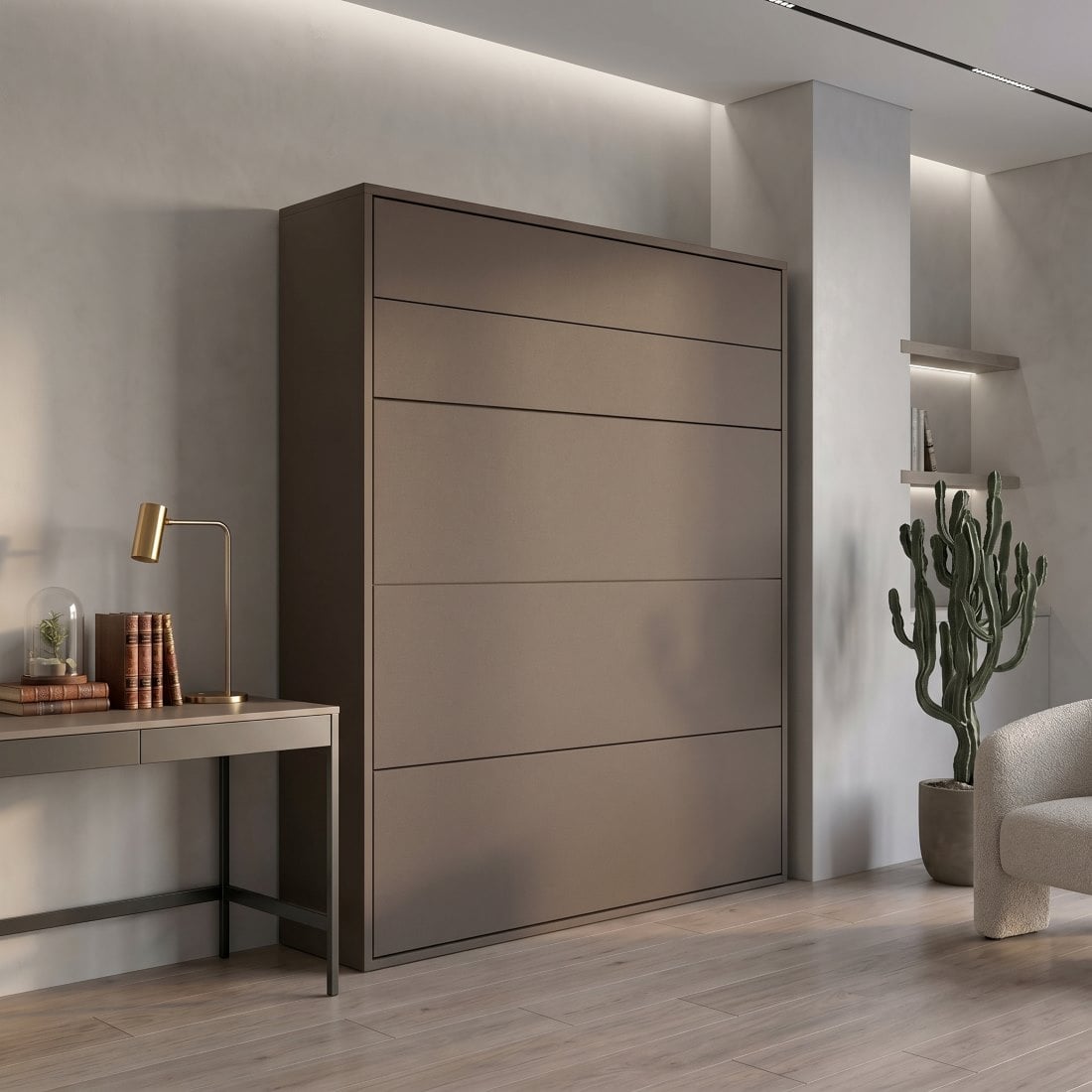 Contemporary interior featuring a tall brown wardrobe, a minimalist desk with a brass lamp, stacked books, and a potted cactus by a soft gray wall.